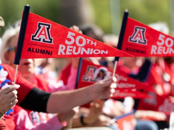 Image of 50th reunion pendant held by alumnus