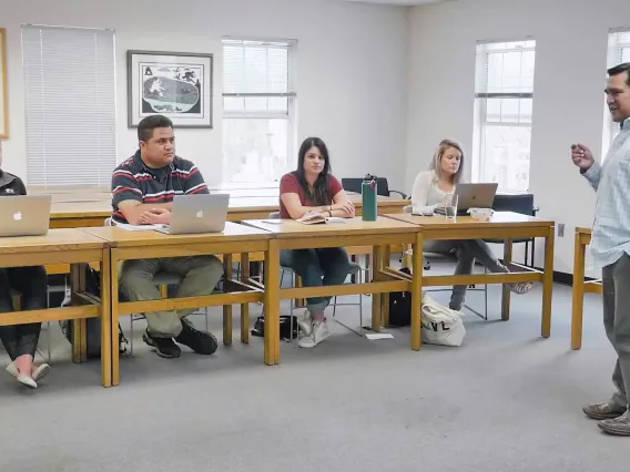 Tory Fodder standing before students sitting at desks