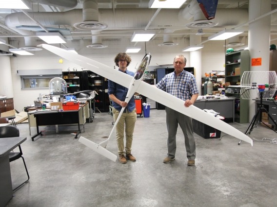 two men folding 11-foot sailplane