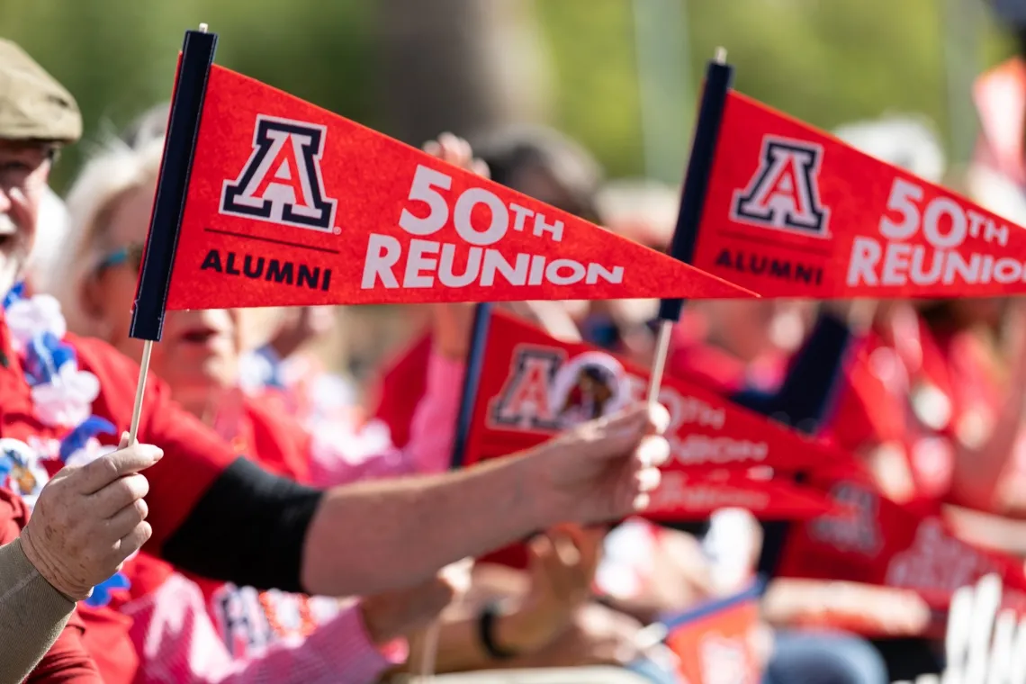 Image of 50th reunion pendant held by alumnus